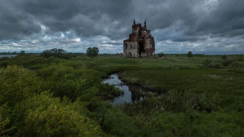 an old castle sitting on top of a lush green field