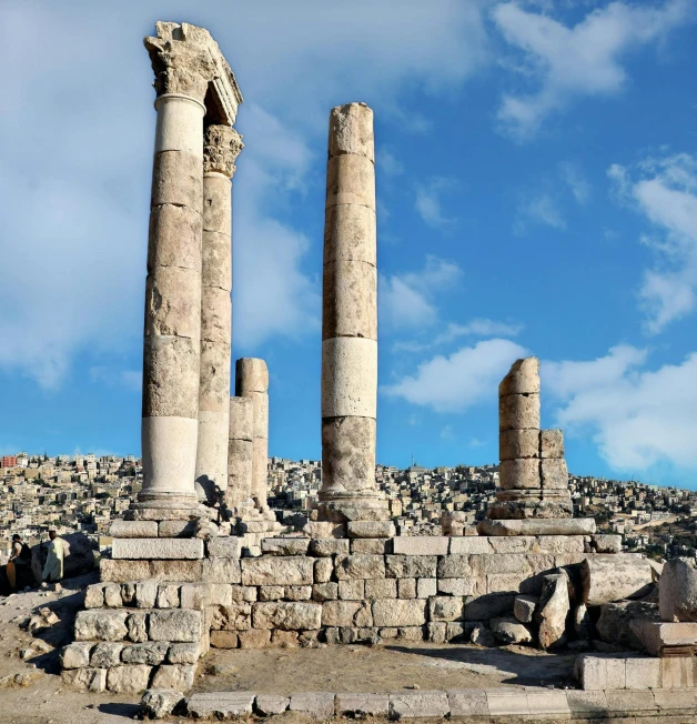 many ruins of ancient architecture with blue sky in the background