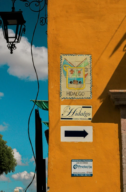 the corner of a building has multiple street signs