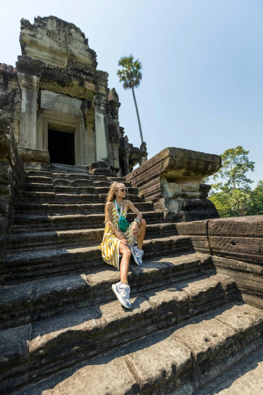 a little girl that is sitting on some steps