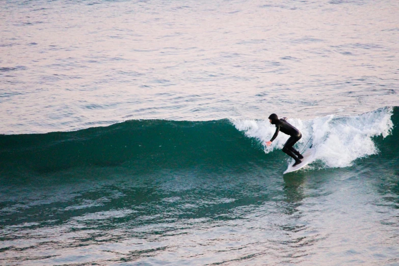 a man on a surfboard riding an ocean wave