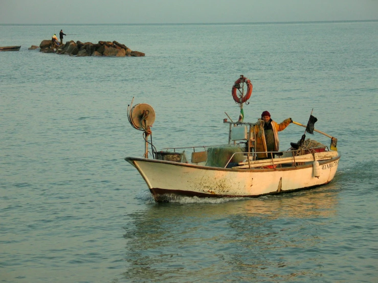 two people in a white boat out on the water