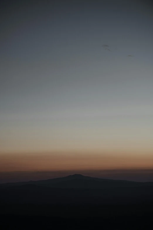 a plane flying through a purple and blue sky