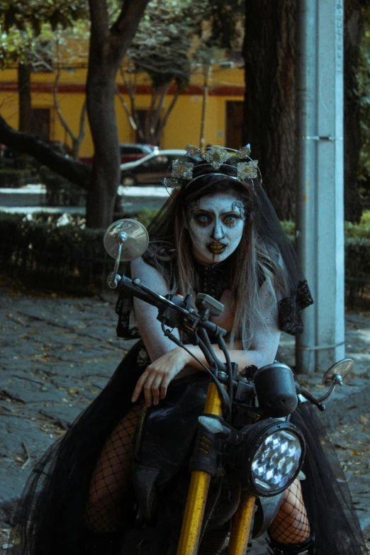 a woman in white makeup with a skeleton head dress on on a motorcycle