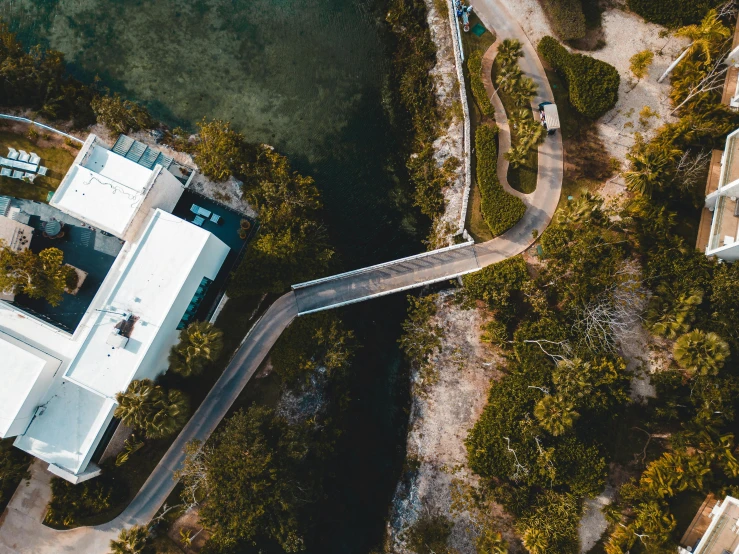 an aerial po of a building in the middle of a tree covered area