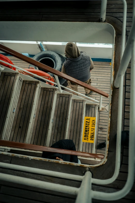 a man in hat is sitting on some steps