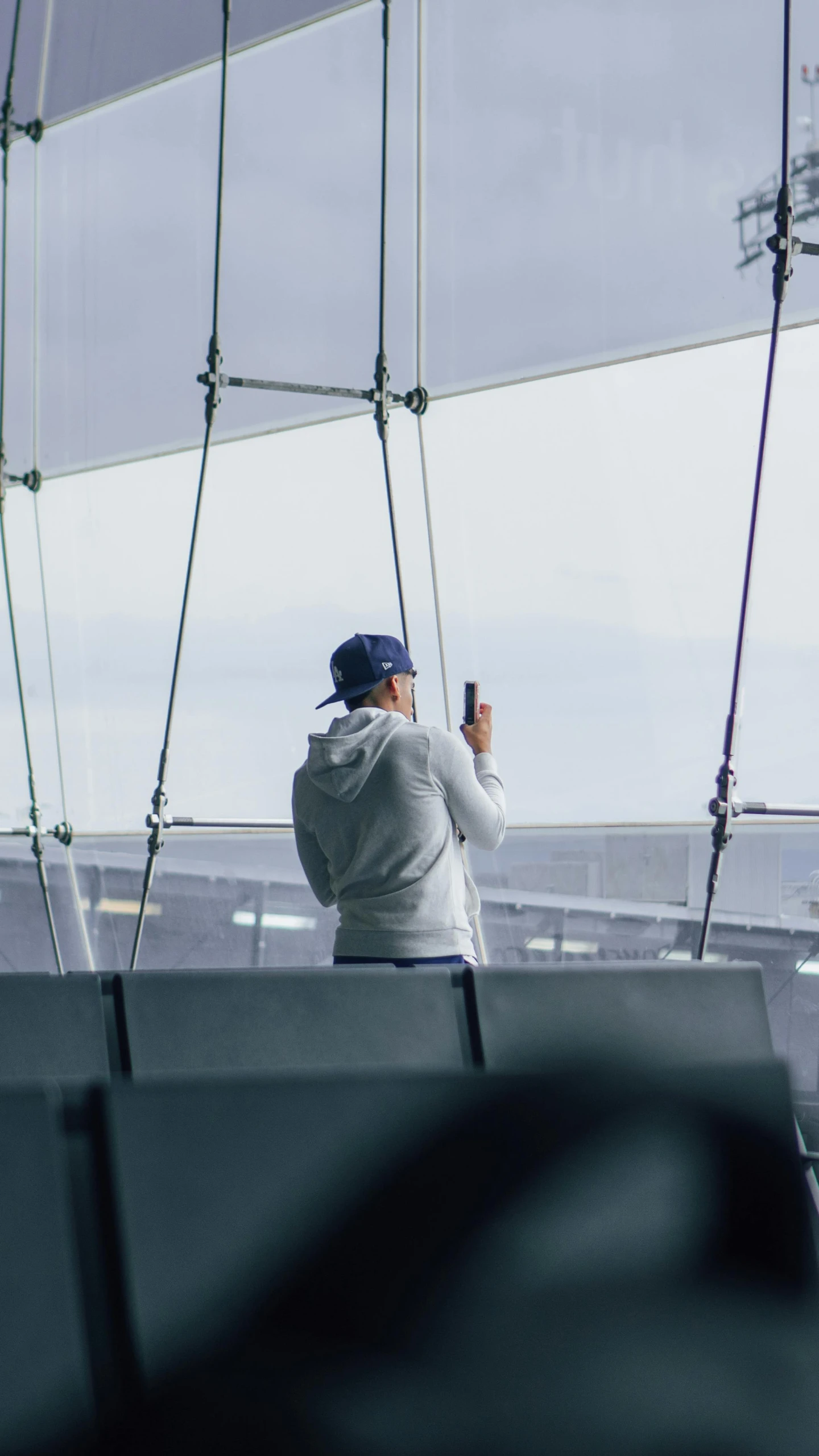 a man standing near the water taking a picture