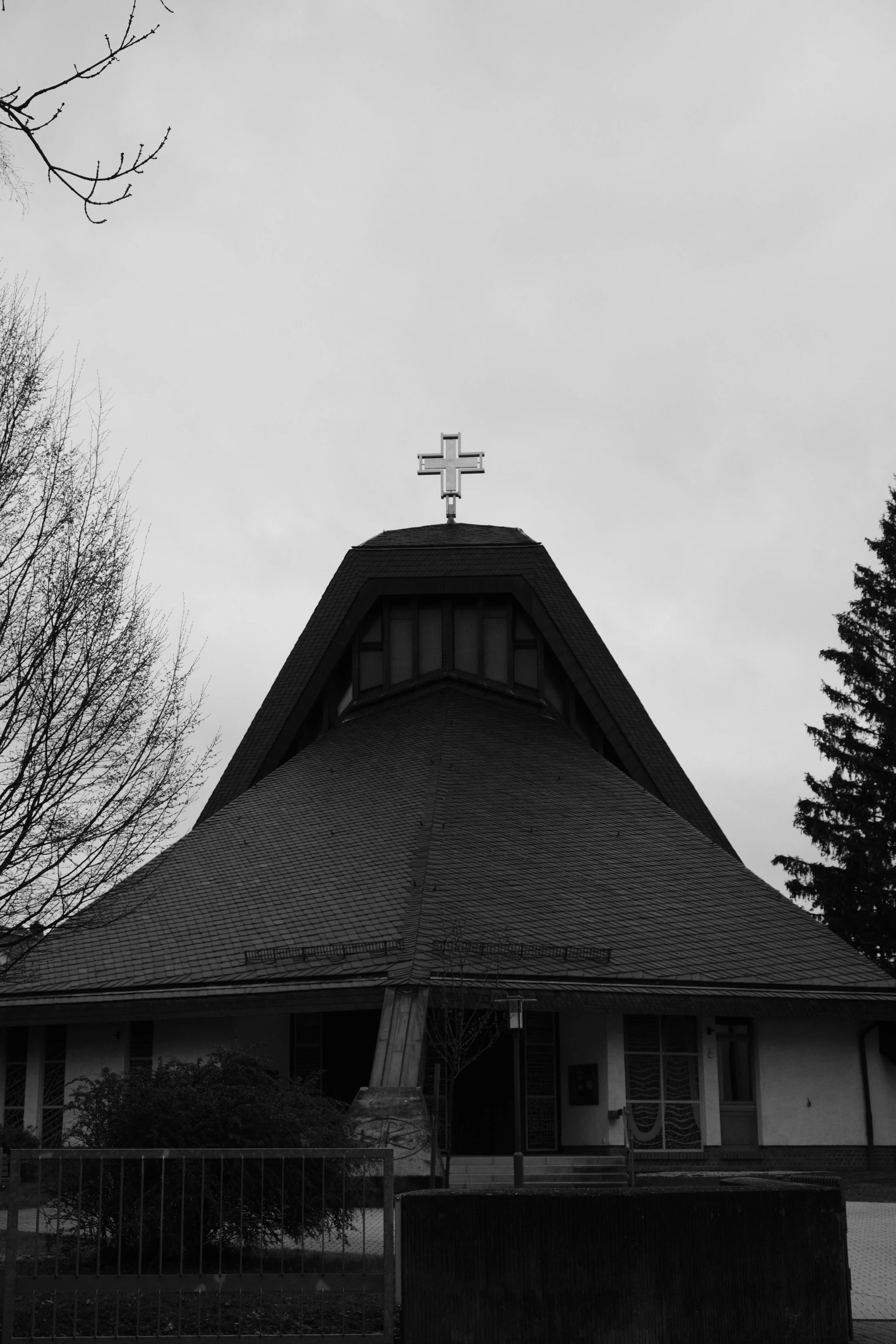 black and white pograph of a small church in the middle of a city