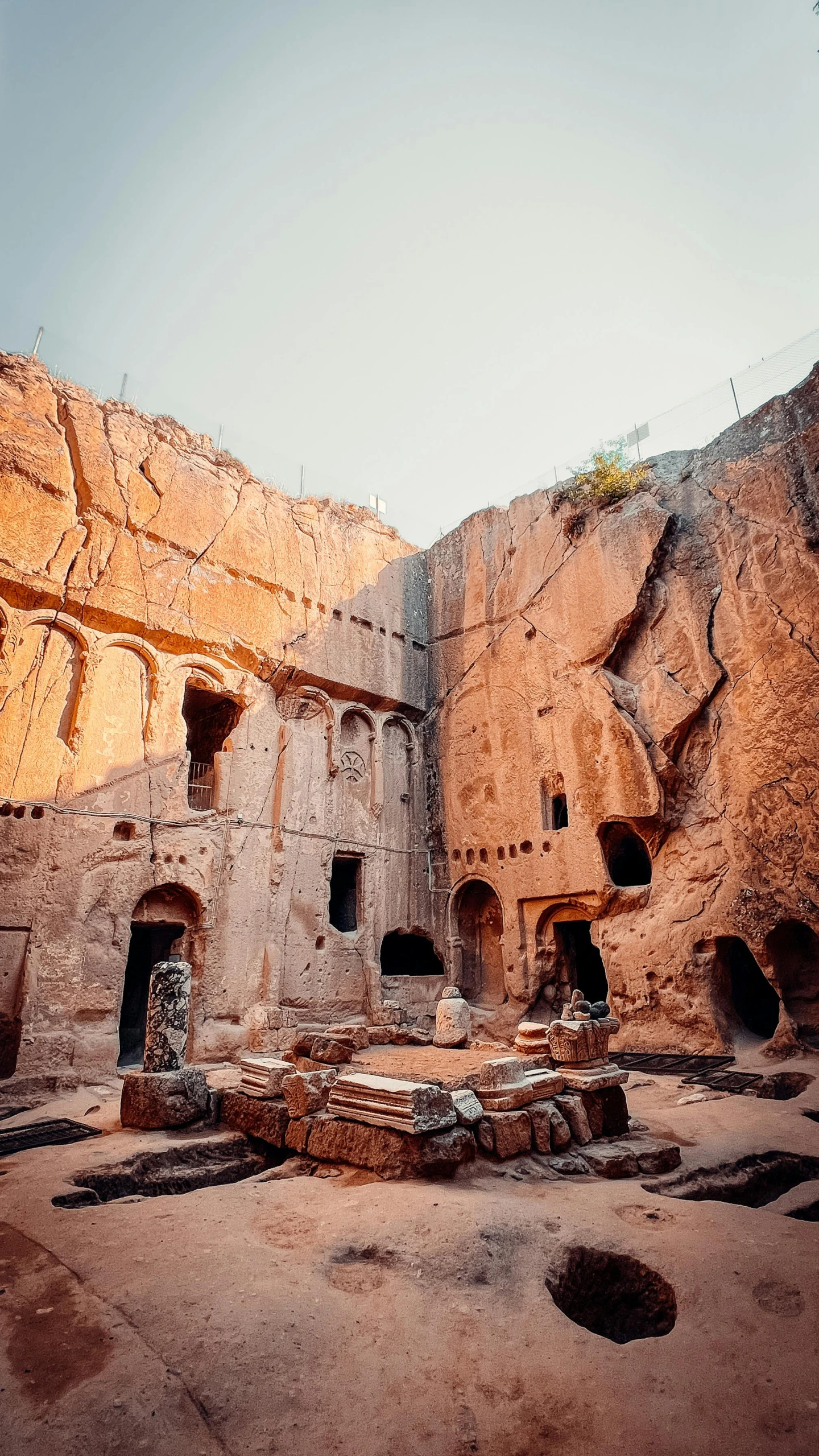 a group of building structures with an area surrounded by large rocks