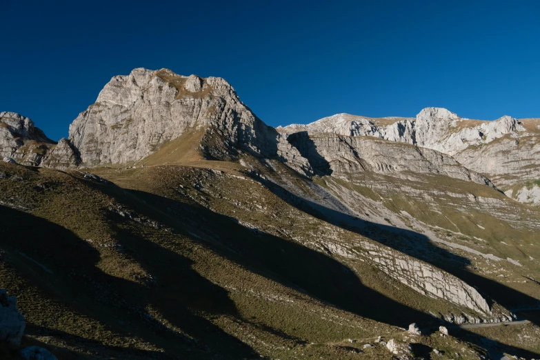 a large mountain peak with shadows on it