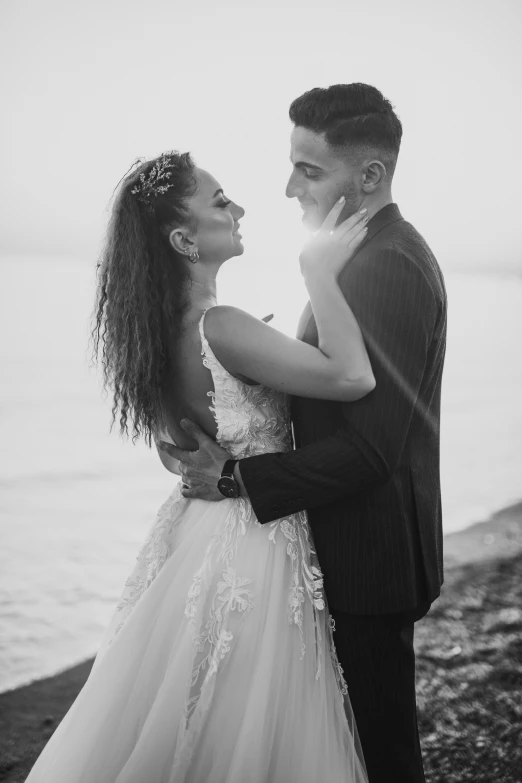 the young couple standing together by the water