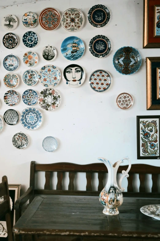 plates are displayed on the wall above a table