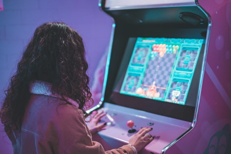 woman playing an old fashioned video game in a brightly lit room