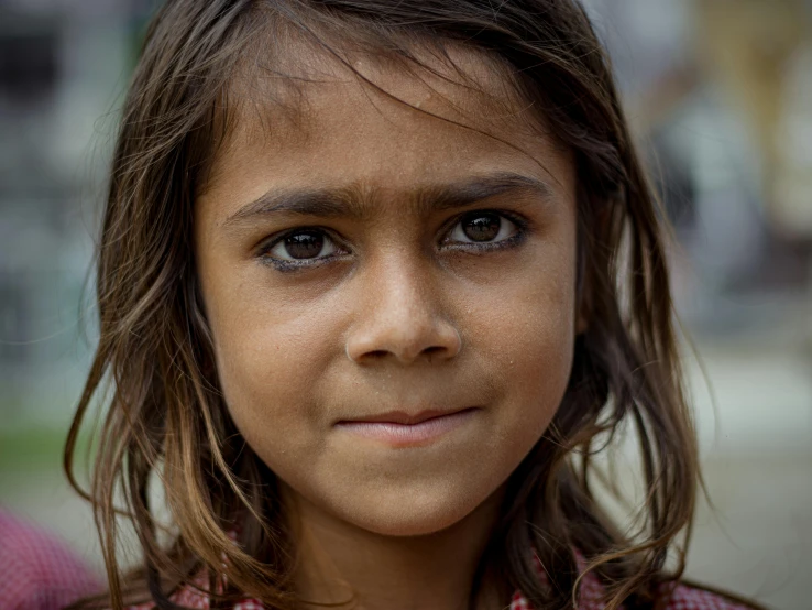 the young child has long dark hair and blue eyes