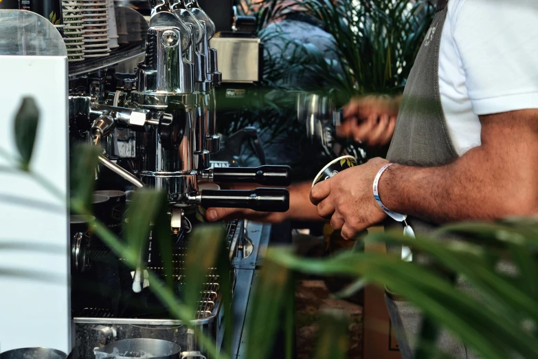 a coffee maker is working with machinery for his drink