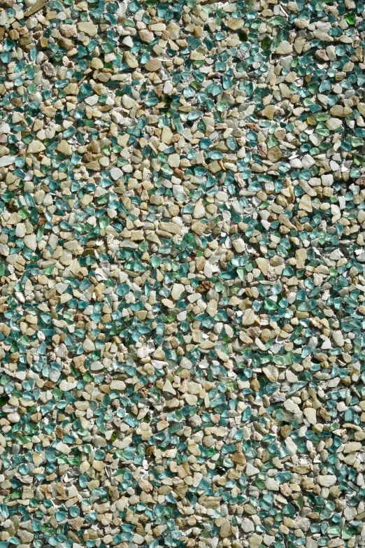 small speckled stones are set against a green, brown and beige background