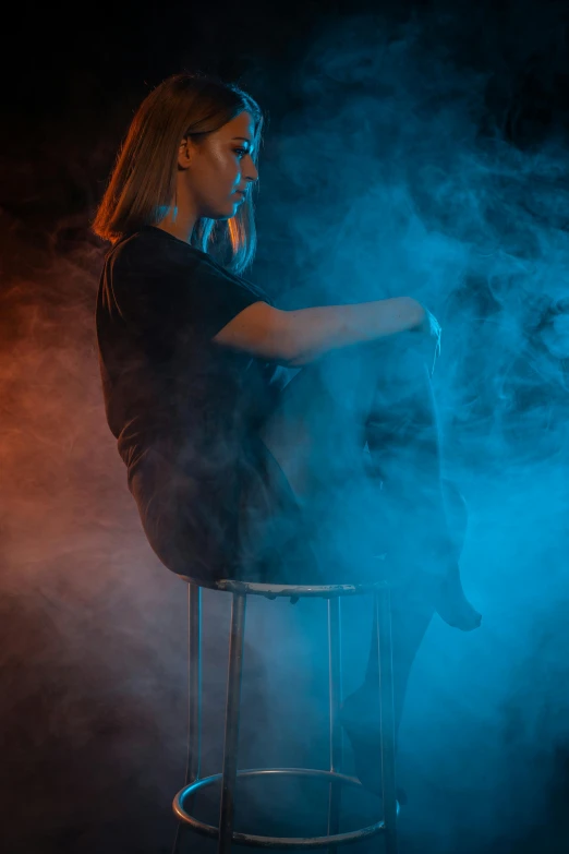 a woman sitting on top of a chair with smoke coming out