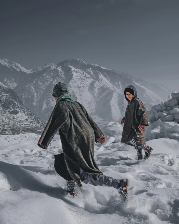 two people walking across the snow covered ground