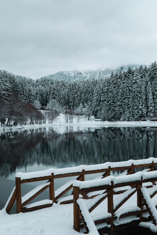 a dock along a river covered in snow