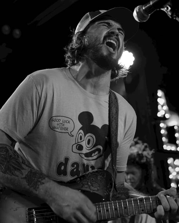 a black and white po of a man playing a guitar