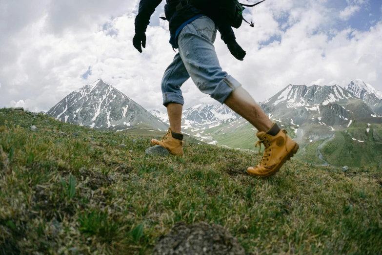 a hiker on a mountain trail is wearing hiking boots