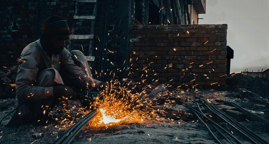 a man who is welding soing on a table