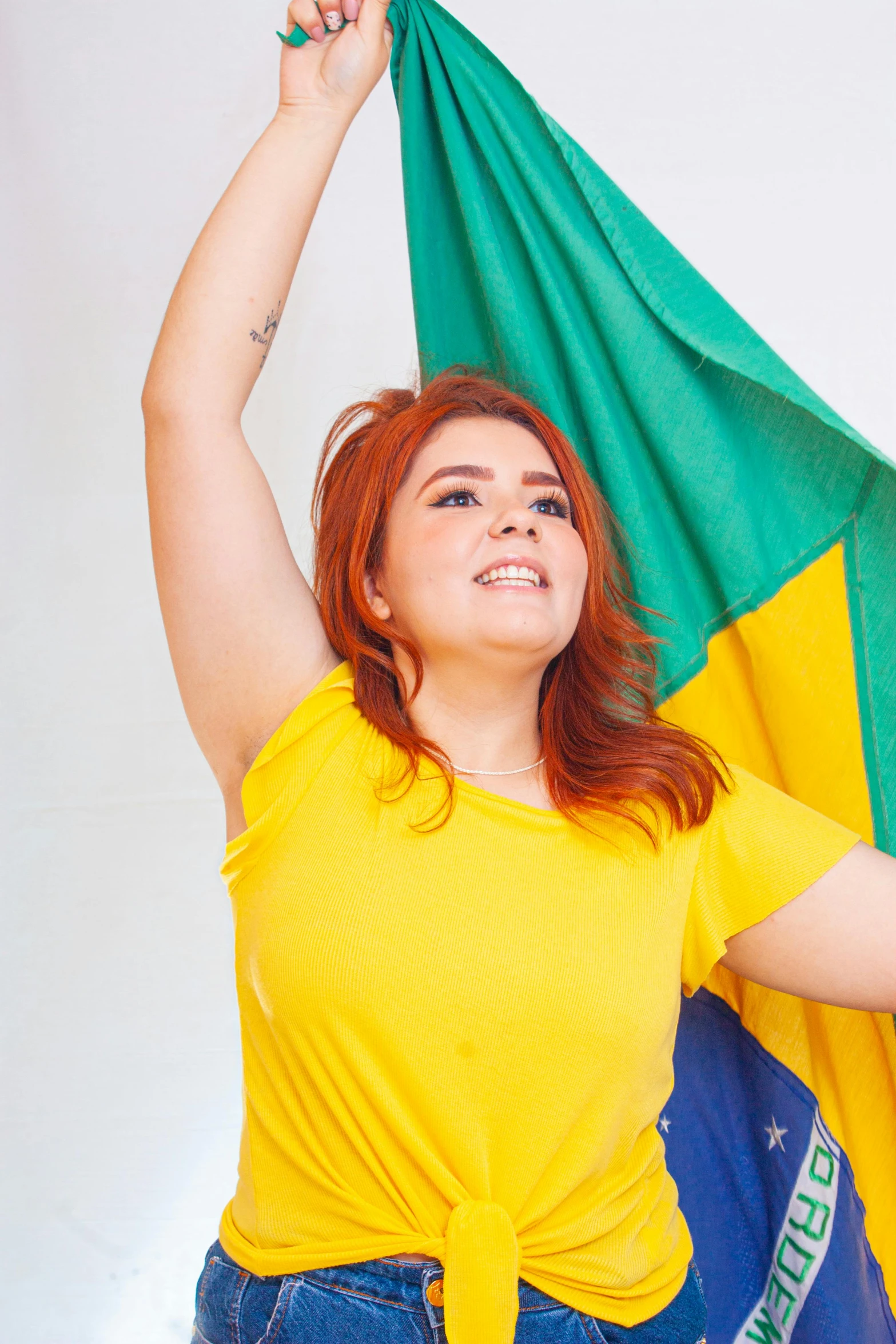 a women holding onto a green and yellow flag