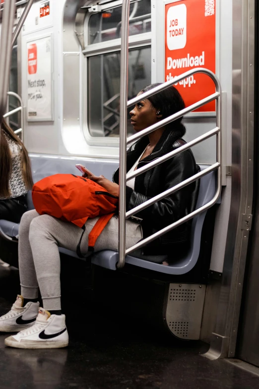 the young woman is sitting by herself in the train