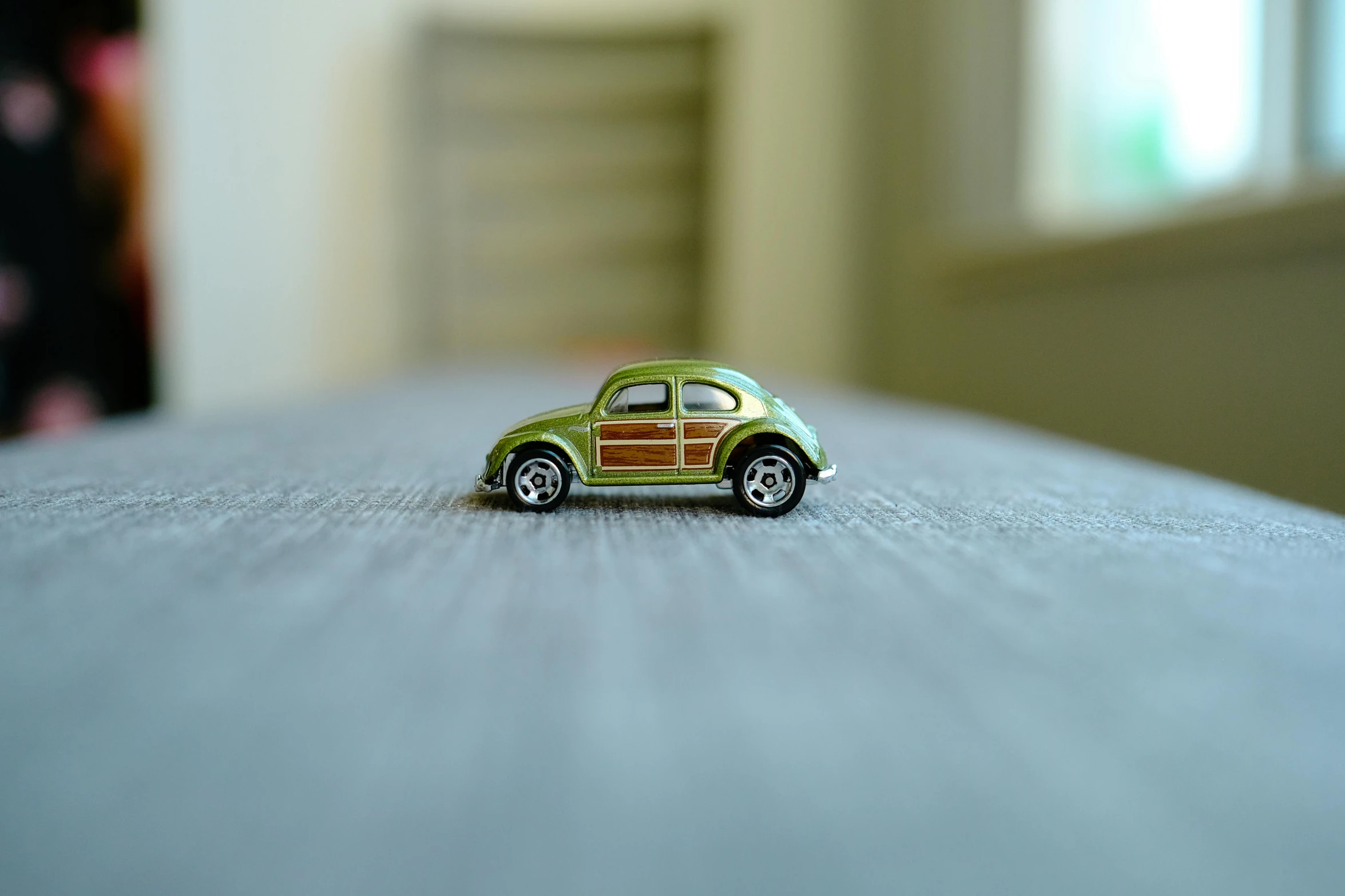 a little car made out of wood is shown on the floor