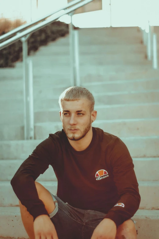 a young man sitting on some steps and stairs