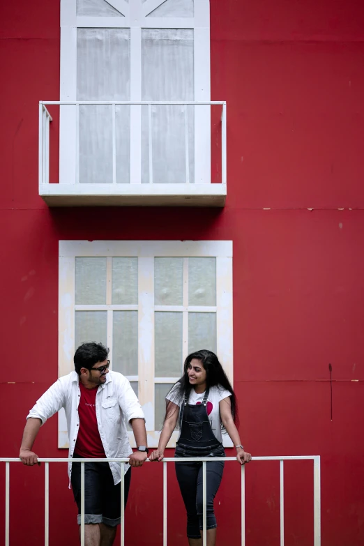 couple standing next to each other on a balcony