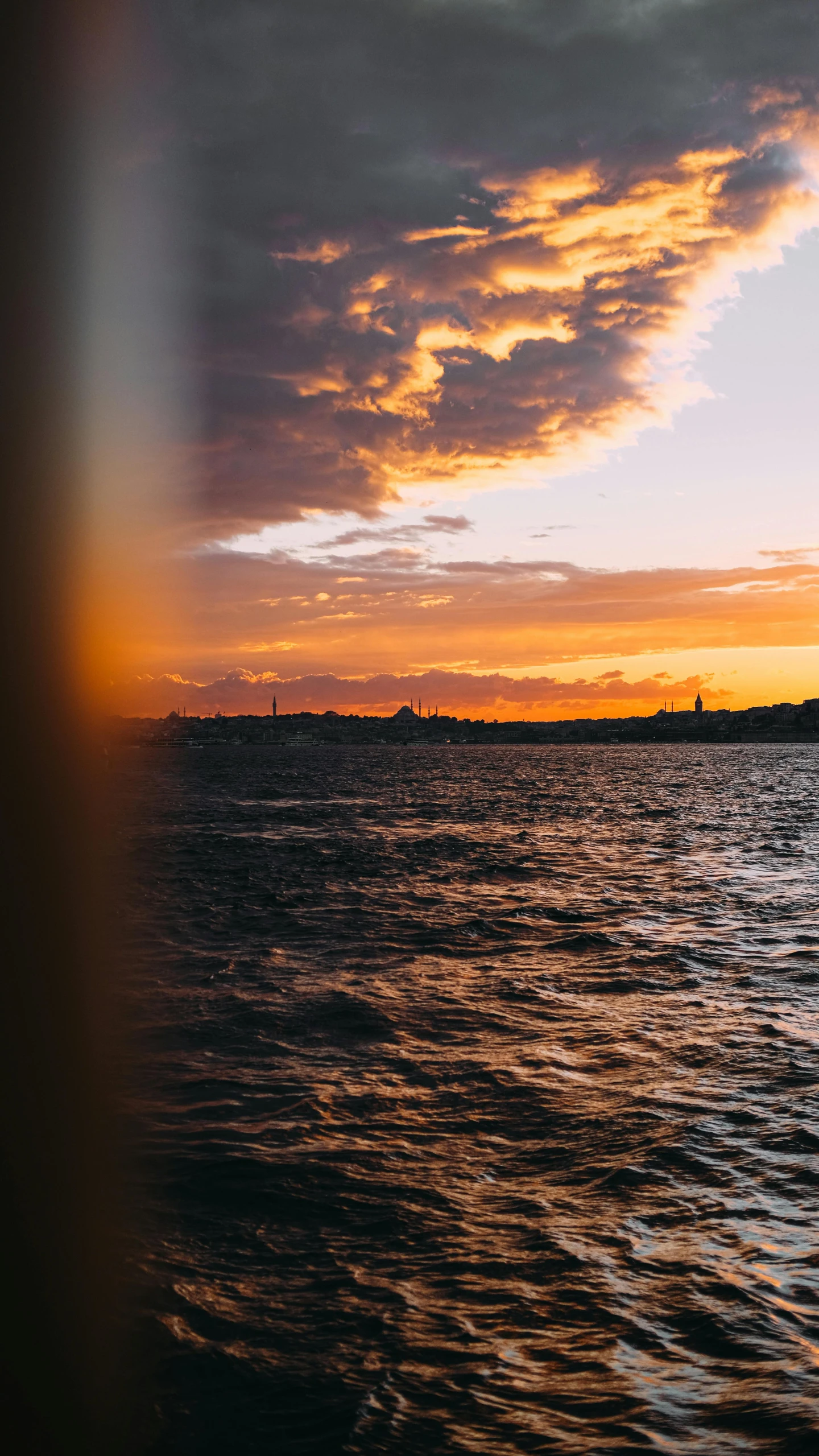 a large body of water with a sunset in the background