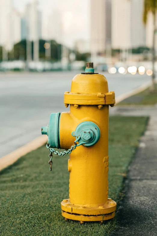 a yellow fire hydrant on the side of the road