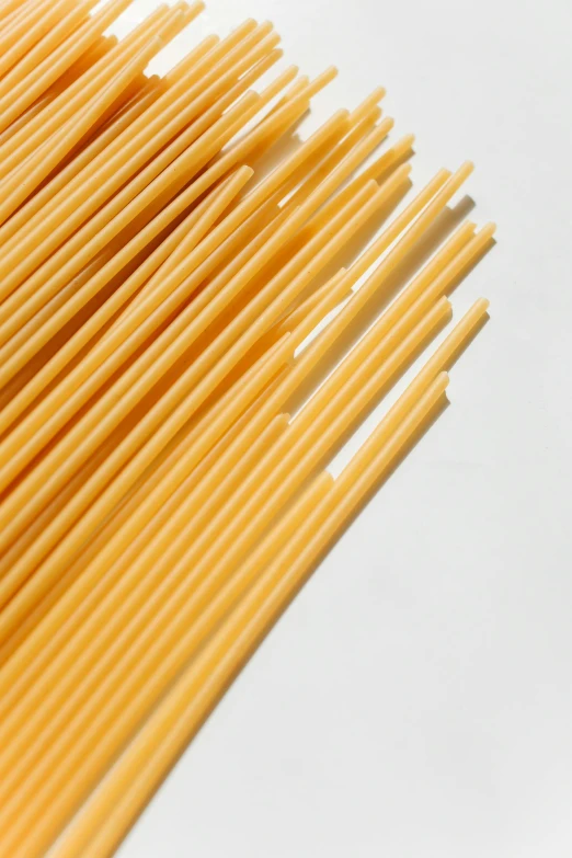 some small yellow tooth picks are on the white background