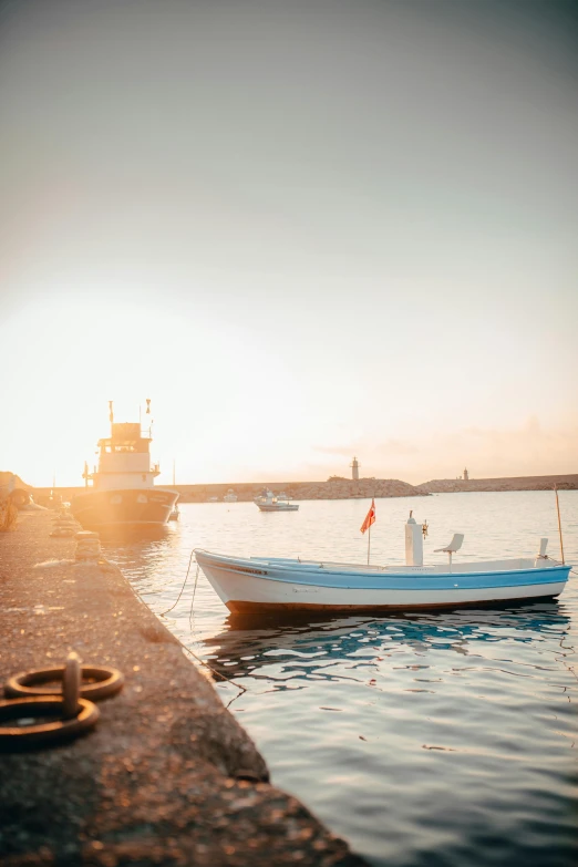 a small boat sits in the water near the pier