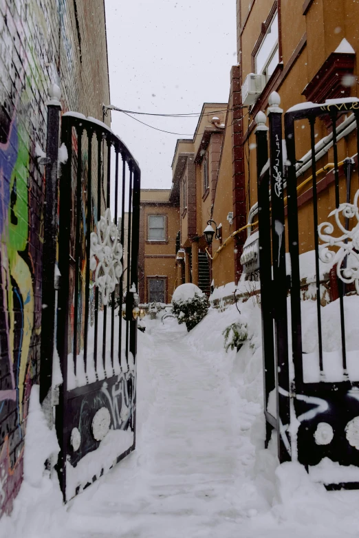 a street scene covered in snow next to some buildings