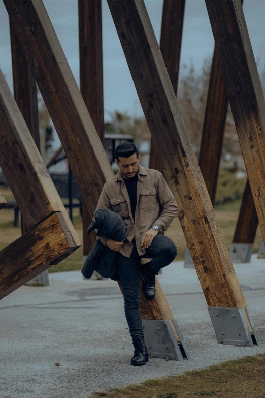 a man sitting on a bench in a park