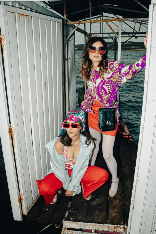 two girls in hippies sitting down on the deck