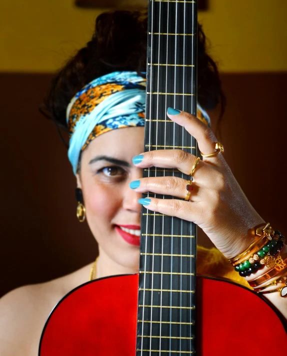 a woman with rings on her head is playing an instrument