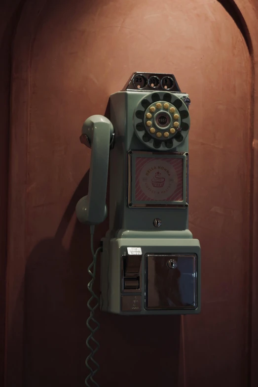 there is an old phone hanging on the wall