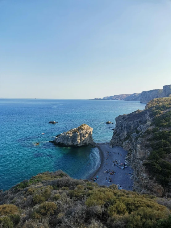 a cliff next to the water with small waves