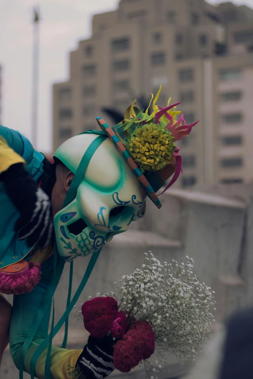 two street performers on a city street next to flowers