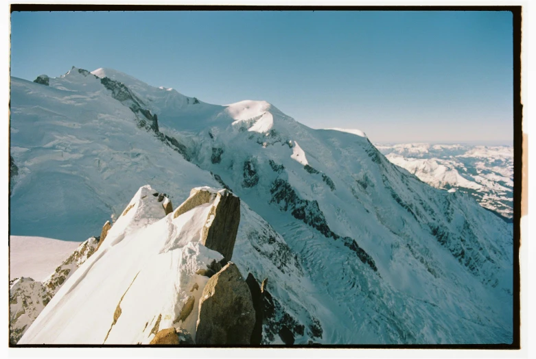 there is snow on the mountain and blue sky