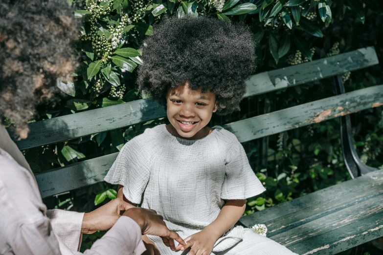 there is a small child sitting on a bench