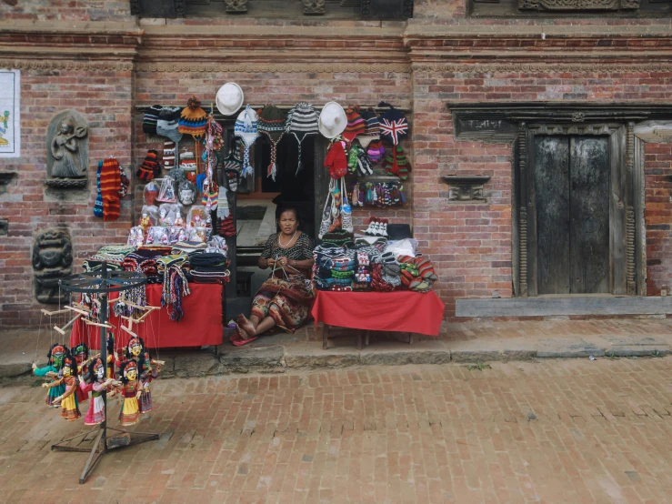 a brick building with two tables on top and other items on the ground