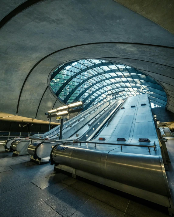 the inside of a train station with many escalators