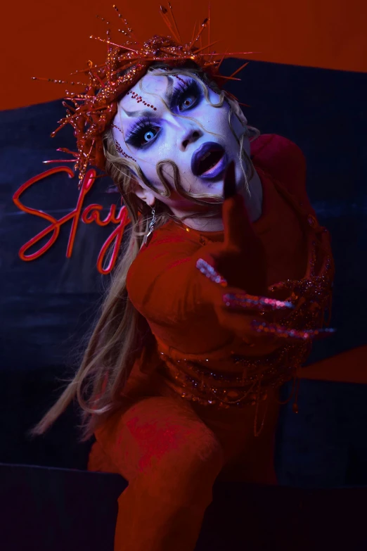 a woman dressed in red and wearing a scary make up