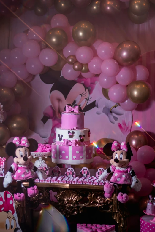 minnie mouse birthday cake and dessert display in front of balloons