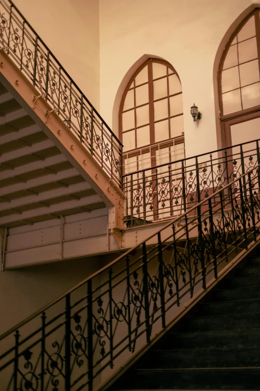 a view of a staircase with open windows at the top