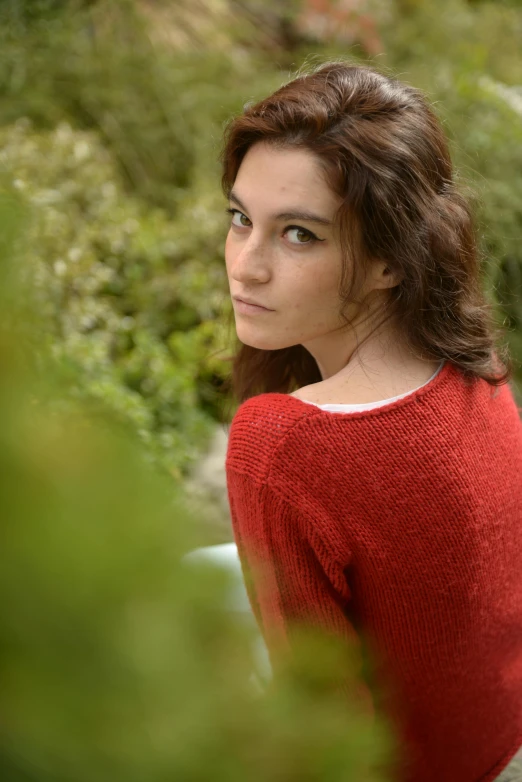 an outdoor portrait of a woman in a sweater